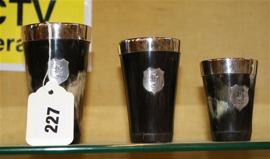 Set of three graduated silver-mounted horn beakers